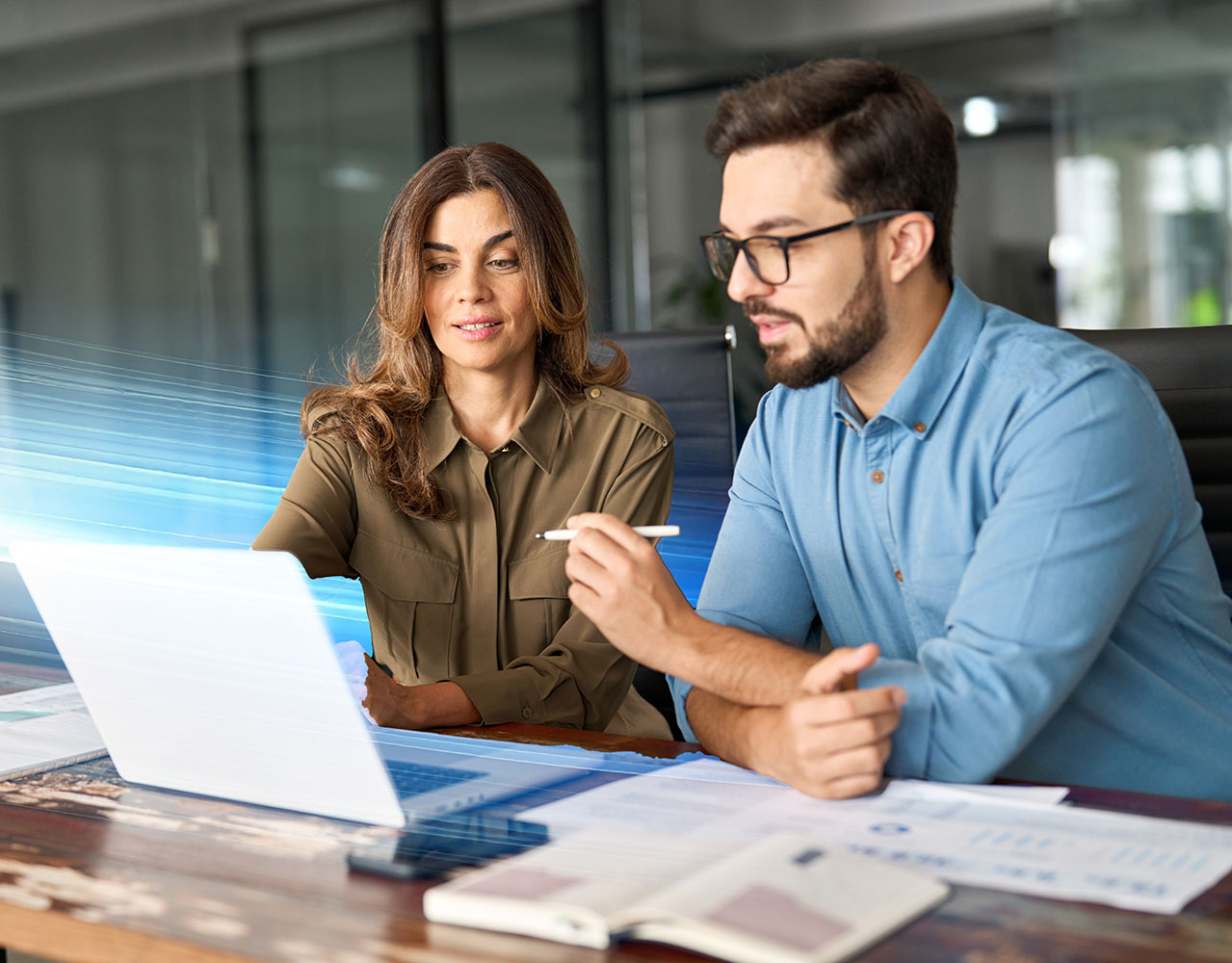 Female and male coworkers working in front of a laptop